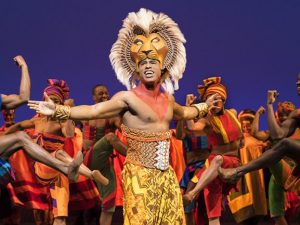 Jared Dixon as Simba with the cast of 