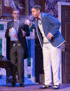 Perkins/Dennis Tyde (Noah Hazard) administers a "Scotch" to spit taking Cecil Haversham/Max Bennett (Keith Claverie) in "The Play That Goes Wrong." (Photo by John Barrois)