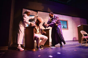 Nanny-Mae (Gwendolyn Foxworth), left, Runna (Danyaé Asante), seated, and Vern-Mayor (Just William Davis) attempt a baptism. (Photo courtesy We Will Dream New Works Festival)